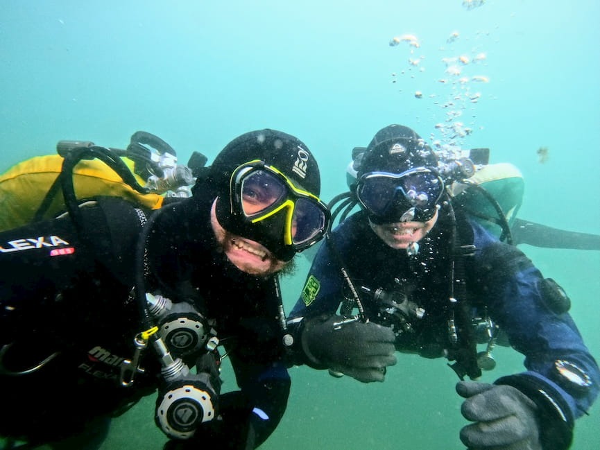 Happy buddy selfie diving in Swiss lake